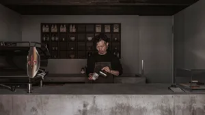 A coffee shop counter made of concrete and wood