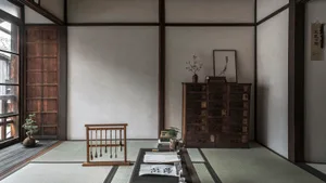A minimalist living room with wooden furniture and tatami mats.