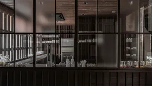 A modern commercial kitchen with metal shelves and various items.