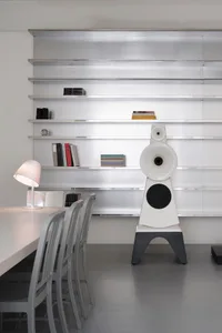 Modern home library featuring white metal shelves and a cement floor
