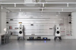 Modern interior with a metal audio system and minimalist design.