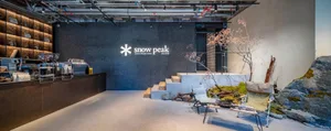 A modern retail storefront with industrial design elements, featuring concrete as the primary building material.