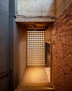 Industrial-style hallway with glass block walls and warm lighting.