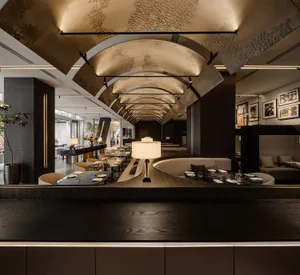 Modern restaurant with metallic ceiling and tables, featuring contemporary design elements.