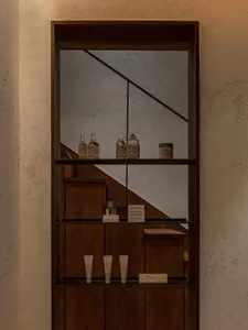 A modern interior display featuring premium products showcased on wood shelves against a textured wall backdrop.