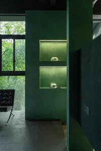 Modern minimalist interior with green plaster shelves and concrete elements
