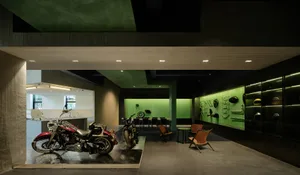 An industrial motorcycle showroom featuring concrete floors and walls.