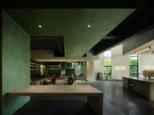 Indoor motorcycle showroom with modern design, concrete floors, and industrial-style furniture.
