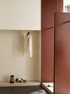 A minimalist closet with a wardrobe, hanger, and boots.