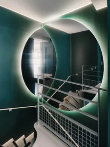 Modern staircase with metallic railings and circular arches.