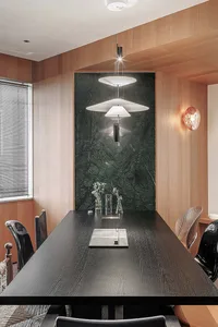 Modern dining room featuring a wooden table, chairs, and pendant lights.