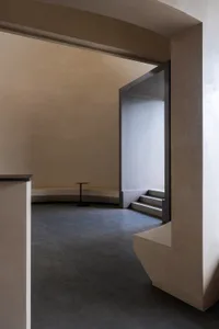 Modern interior space with concrete flooring and minimalist design elements.