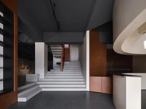 Modern lobby area with concrete stairs and walls
