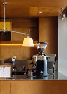 Modern coffee shop with a coffee roaster mounted on a wooden wall.