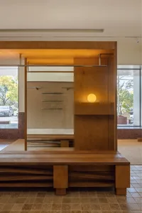Modern storefront with wooden elements and glass doors.