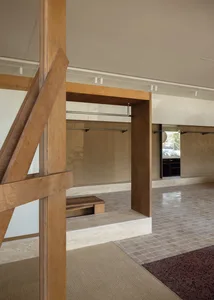 Minimalist living space with wood, tile, and carpet flooring.