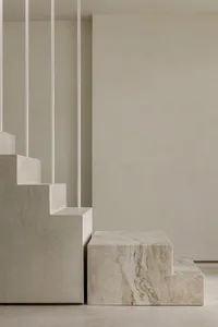 Modern interior design featuring marble and concrete stairs.