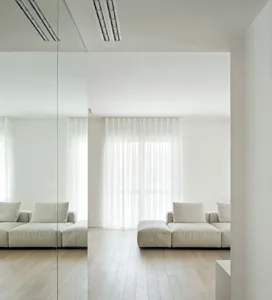 A minimalist living room with a white curtain