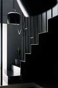 Modern minimalist interior design featuring glass stairs and black elements.