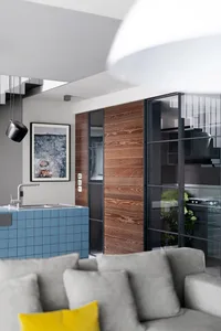 Modern living room featuring glass, wood, and blue tiles