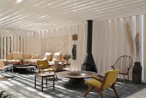 A modern living room with wooden furniture, upholstered sofas, and a glass fireplace.