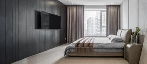 Modern minimalist bedroom featuring textured wood walls, a suede headboard, and a glass window with cityscape view.