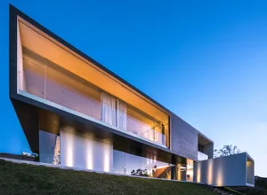 A modern house with large windows and metal frame