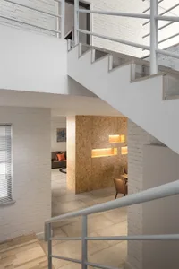 Modern and industrial-style office lounge featuring a combination of white and wooden elements.