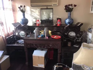 A Chinese interior design scene with wooden furniture and decorative items.