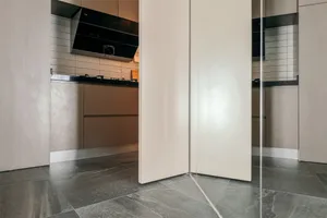 Modern kitchen featuring wooden cabinets and a marble countertop.
