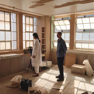 A construction site featuring wooden paneling with boxes and materials.