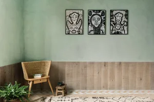 A modern room with wooden paneling and a wicker chair.