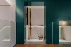 Modern entryway with terrazzo flooring and minimalist design elements.