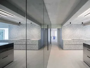 Modern industrial kitchen with concrete walls and floor.