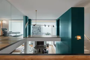 A modern living room featuring glass walls, a minimalist design, and sleek furniture.