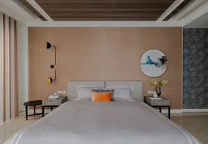 A modern minimalist bedroom featuring neutral tones, a stylish bed with a headboard, and sleek, functional nightstands.