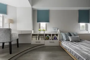 A minimalist bedroom with a wood-patterned floor, grey furniture, and turquoise accents.