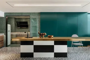 A modern residential kitchen featuring a terrazzo kitchen counter top, black and white checkered bottom cabinets, and a green