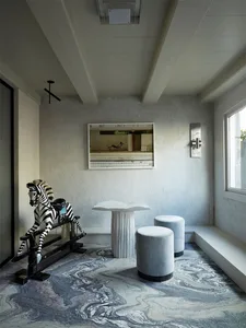 A minimalist living room featuring concrete elements, a rocking horse, and modern furniture.