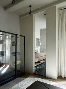 A modern bathroom featuring a marble floor and light-colored walls.