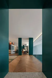 Modern interior corridor featuring blue-green pillars and terrazzo tiles floor
