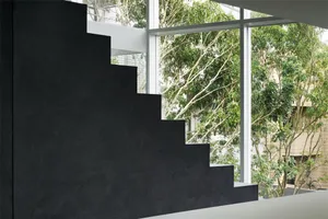 A modern, minimalist staircase made of concrete, featuring industrial design elements and a contemporary aesthetic, with view