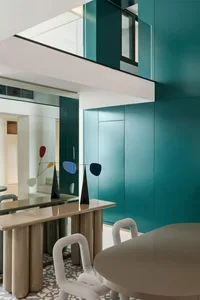 Modern dining room with a combination of terrazzo tiles and metallic structures, featuring minimalist furniture and a unique 