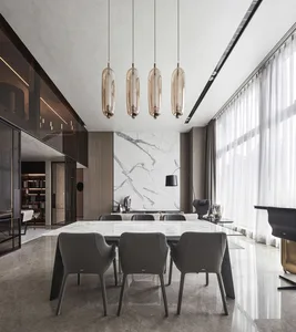 A modern dining room featuring a marble table and minimalist design.