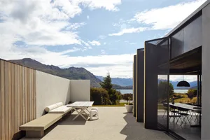 Modern exterior residential landscape featuring wood and concrete materials.