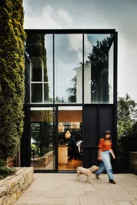 A modern home with large glass panels on its exterior wall.