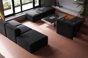 A modern, industrial-style living room featuring concrete furniture and minimalist decor.