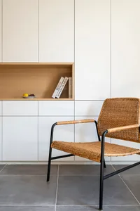 Modern minimalist living space featuring a woven armchair.