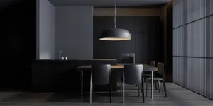 A modern kitchen with black marble countertops and black cabinets