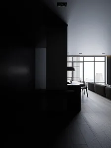 A minimalist apartment living room with black and white color scheme, featuring sleek, modern furniture and a large window wi